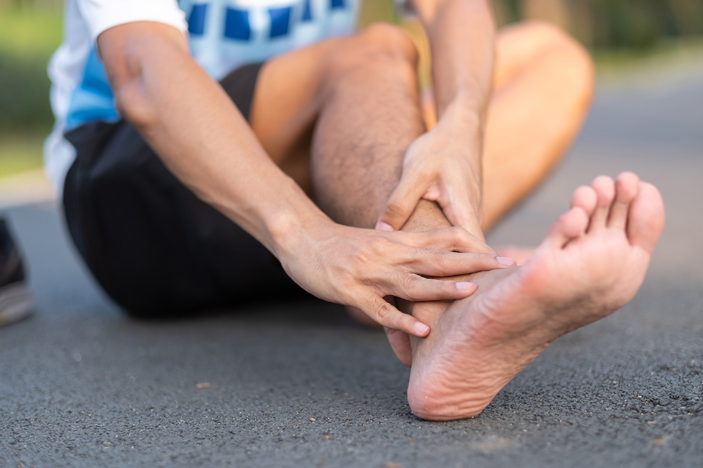 What causes pain on the top of the foot near the ankle?